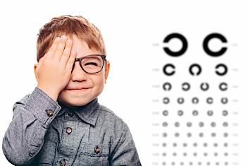 Young kid doing a vision test for myopia (nearsightedness)